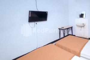 Postel nebo postele na pokoji v ubytování Hotel Palem 1 Syariah RedPartner