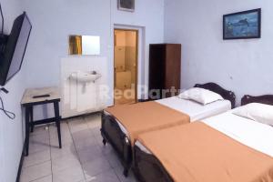 Postel nebo postele na pokoji v ubytování Hotel Palem 1 Syariah RedPartner
