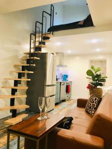 a living room with a couch and a staircase at Luxury City Tiny House in Denver