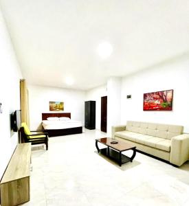 a living room with a couch and a bed at Salvador Dali Apartments in Amman