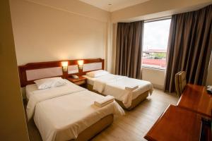 Postel nebo postele na pokoji v ubytování Somerset Hotel + 24 fotografií