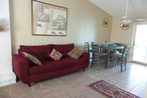 a living room with a red couch and a table at Water Front Sweet Home in Mesa