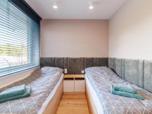 a bedroom with two beds and a window at Holiday apartment near the beach in Rowy in Rowy