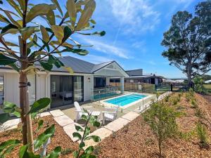 an image of a house with a swimming pool at Florette's Retreat in Pokolbin