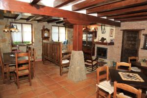 a living room with wooden furniture and a fireplace at Gane Landetxea in Barrika