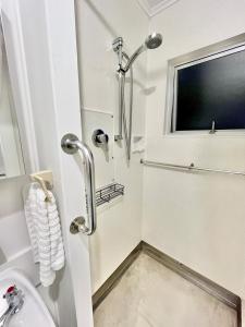 a bathroom with a toilet and a window at House of Somer in Matamata
