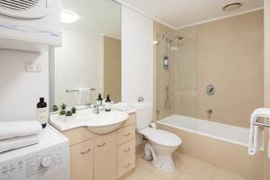 a bathroom with a sink and a toilet and a shower at Melbourne CBD Apt With A C Balcony & Pool in Melbourne