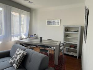 a living room with a table and a couch at Appartement Royan, 3 pièces, 4 personnes - FR-1-539-52 in Royan