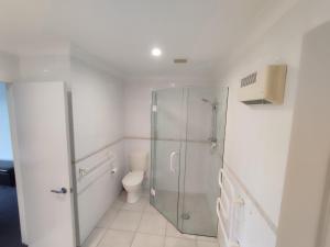 a bathroom with a glass shower and a toilet at panoramic vista with sea views in New Plymouth