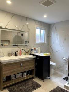 a bathroom with a sink and a toilet at Modern, Spacious & Great Location Home in Mississauga