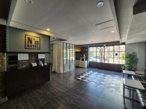 a lobby of a hotel with a sign on the wall at No. 25 Hotel Myeongji Oceanc City Business in Busan