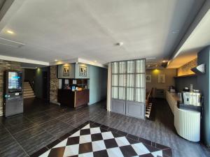 a lobby with a checkered floor in a building at No. 25 Hotel Myeongji Oceanc City Business in Busan