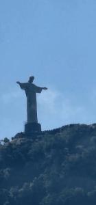 a statue of christ the redeemer on top of a hill at Copa Alegria - Conforto, praia e comodidade in Rio de Janeiro