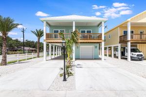 a house with a balcony and a garage at Fishtastic SP103 in Rockport