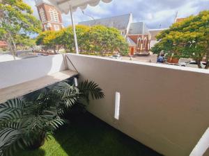 a concrete wall with a plant next to it at Exclusive location - 3-bedroom Unit in Maryborough CBD, 10ppl in Maryborough