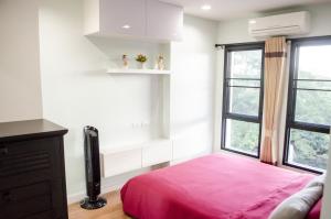 a bedroom with a pink bed and a window at Blue and green Farang homes in Chiang Mai +35 photos