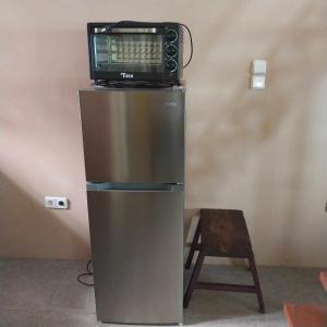 a microwave sitting on top of a refrigerator at Beach House Sibuyan via Cresta de Gallo in San Fernando