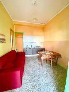 sala de estar con sofá rojo y mesa en Casa Levante en Cefalú