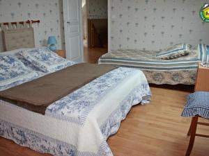 une chambre avec deux lits et un parquet dans l'établissement Charmant gîte familial à Fiennes, 2 chambres, jardin privé, terrasse, proche Wissant, animaux acceptés - FR-1-376-118, à Fiennes