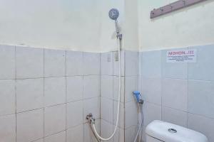 a bathroom with a shower and a toilet at RedDoorz near Alun Alun Cianjur in Cianjur
