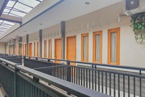 a row of orange doors on a building at RedDoorz near Alun Alun Cianjur in Cianjur