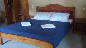 a large bed with two towels on top of it at Beach House Sibuyan via Cresta de Gallo in San Fernando