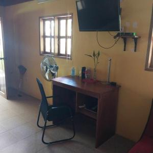 a desk with a fan and a chair in a room at Beach House Sibuyan via Cresta de Gallo in San Fernando