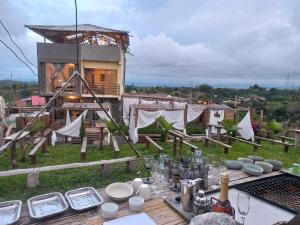 a table with plates and glasses on top of a field at Vibras in Popayan