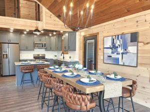 a large kitchen with a long table and chairs at A Splashing Good Time in Sevierville