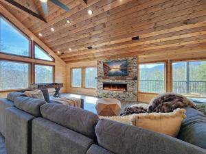 a living room with a large couch and a fireplace at A Splashing Good Time in Sevierville