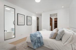 a white bedroom with a bed and a tub and a sink at Beautiful Townhome In Mirabel in Mirabel