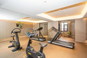 a gym with several exercise bikes in a room at Ji Hotel Yantai Guanhai Road Fisherman's Wharf in Qianqikuang