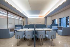 a conference room with tables and chairs in it at Hanting Hotel Nantong Yuan Rong Square in Nantong