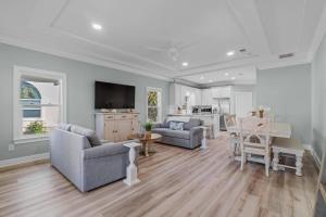 a living room with two couches and a table at Calatrava Beach Cottage Pet Family Friendly in Destin