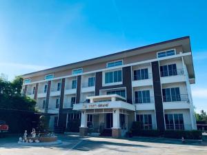 a large building with a sign that reads the hotel maid at NewDhara Place Lom Sak Hotel in Phetchabun