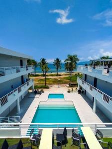 a swimming pool with a view of the ocean at THE SHORELINE SUBIC HOTEL in Olongapo