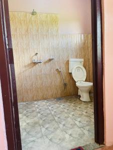 a bathroom with a toilet in a room at Hotel Tree Tops in Sauraha