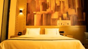 Postelja oz. postelje v sobi nastanitve City Comfort Inn Kashi Banchao Ancient City