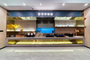 a lobby of a building with a counter with blue at Starway Hotel Shangrao High-Speed Railway Station in Shangrao