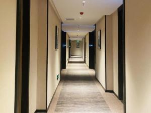 a corridor of a hallway with a long aisle at Green Tree Inn Huhhot Yuquan District South Campus of University of Inner Mongolia in Hohhot