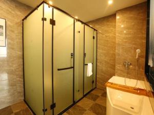 a bathroom with a shower and a toilet in it at Green Tree Inn Shandong Dongying Lijin County Phoenix Plaza in Litsinghsien