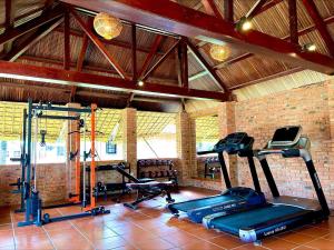 a gym with several treadmills and exercise bikes at ENSO Retreat Hoi An in Hoi An