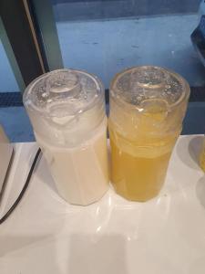 two jars of liquid sitting on top of a table at 남대문시장 중심의 스타힐스호텔 in Seoul