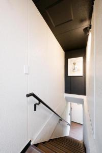 a stairway with a railing and a stair case at HOSTEL LUND I -Oimachi- in Tokyo