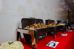 a table with a bunch of food on top at ALAZMI HOTEL in Al Khān
