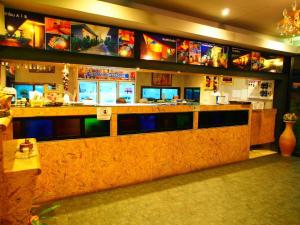 a restaurant with a bar with monitors on the wall at เมล่อนลอยฟ้า in Ban Kaeo