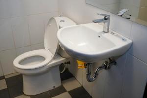 a bathroom with a toilet and a sink at Hotel Aquarium Indonesia Pangandaran in Pangandaran