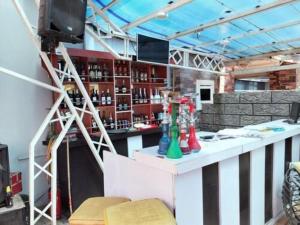 a bar in a room with a counter and a television at Easton Hill Continental Hotel in Enugu