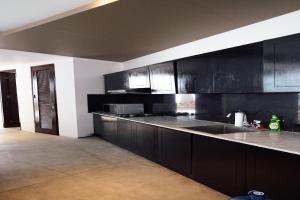 努沙杜瓦的住宿－De Camoes Villa，厨房配有黑色橱柜和台面