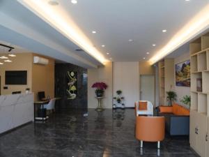 an office lobby with a reception desk and chairs at GreenTree Inn Express Dongying Municipal Governemnt Wanda Plaza in Dongying
